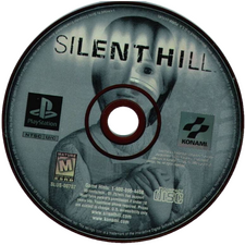 Silent Hill a pale green CD labelled Silent Hill with one of the character's, Cheryl, on it. She's a young girl with short black hair with a sweater on. This links to my blog's 'Silent Hill' tag